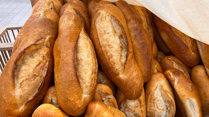 Many bread on sale at a market stall.
