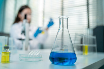 A glass tube filled with chemical liquid in biotechnology laboratory.