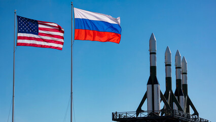 Flags of America and Russia Fluttering Beside Black and Silver Military Rockets