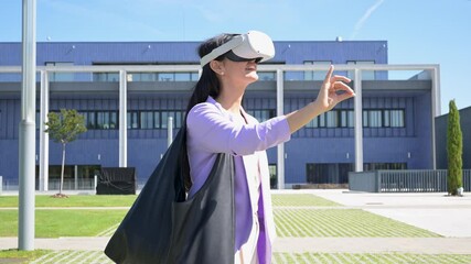 Businesswoman interacting with virtual reality headset outdoors - Powered by Adobe