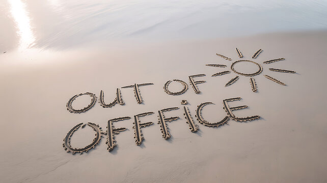 Out of office message written in sand near a drawing of a sun symbol on beach