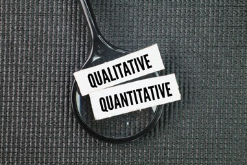 magnifying glass and paper with the words quantitative and qualitative