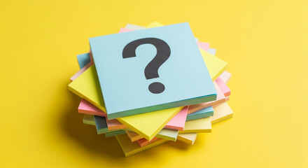 Stack of colorful sticky notes, top note displays a question mark, symbolizing inquiry, problem-solving, or brainstorming concepts