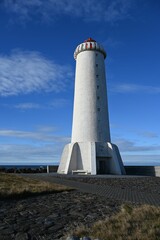 Striking white lighthouse against a vivid blue sky
