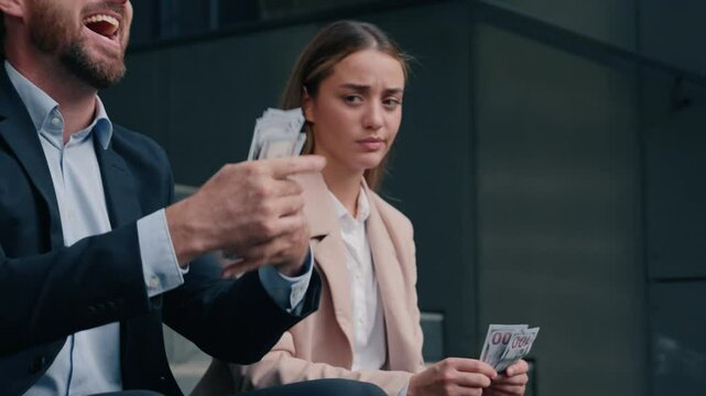 Two co-workers business man and woman in city counting money wealthy male kissing cash sad female with small salary businessman businesswoman gender job problem inequality financial discrimination