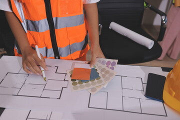 Closeup of team of industrial engineers meeting analyze machinery blueprints consult project on table in manufacturing factory. Working in manufacturing plant or production plant.
