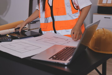Closeup of team of industrial engineers meeting analyze machinery blueprints consult project on table in manufacturing factory. Working in manufacturing plant or production plant.