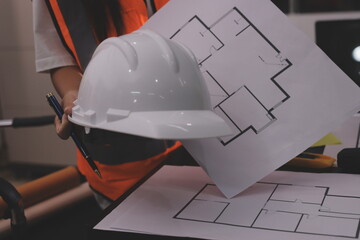 Closeup of team of industrial engineers meeting analyze machinery blueprints consult project on table in manufacturing factory. Working in manufacturing plant or production plant.
