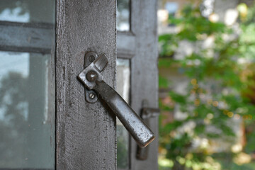 Rustic Metal Window Latch on Weathered Wooden Frame With Copy Space - National Carpenters Day