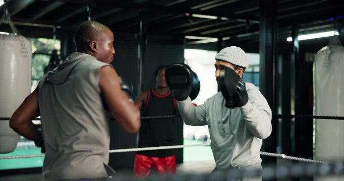 Coach, boxing and men with gloves for practice, active or training for self defense, fitness or gym. Boxer, fight and preparation for competition, personal trainer and battle with athlete for sport