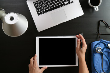 Doctor Holding Tablet with Stethoscope and Medical Tools on Desk
Doctor Holding Tablet with Stethoscope and Medical Tools on DeskDoctor Holding Tablet with Stethoscope and Medical Tools on Desk