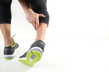 Runner with Ankle Injury Holding Leg