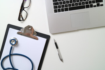 Doctor's Desk with Laptop, Clipboard, and Stethoscope