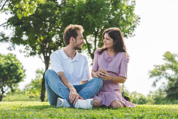 Fototapeta premium Young lovers walk hand in hand in the park Romanticly. On a relaxing holiday