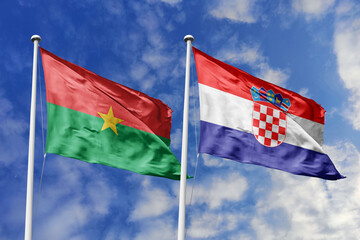 A Burkina Faso and Croatia flag, a metaphor for Balkan-African ties, wave together against a blue sky, symbolizing friendship and cultural exchange.