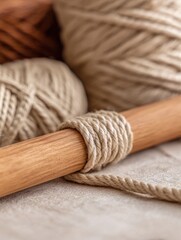 Close-up of natural fiber yarn spools on a wooden surface, showcasing crafting materials and textures