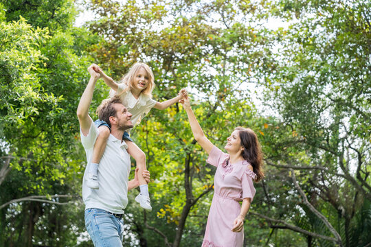 Happy family parent children having picnic outdoor activity. Enjoy happiness moment summer playing together including father mother son and daughter relaxing in the morning sunrise.