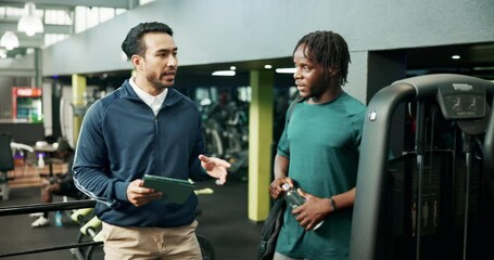 Man, personal trainer and planning with tablet in gym for development of training program. App, conversation or exercise with client and fitness coach in club for consulting on workout schedule - Powered by Adobe
