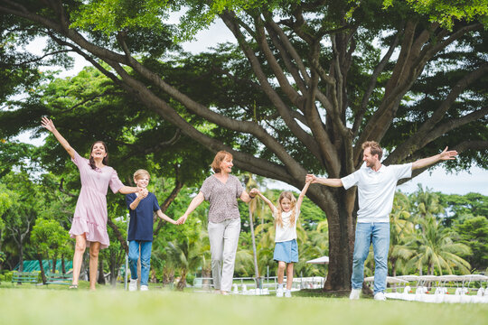 Happy family parent children having picnic outdoor activity. Enjoy happiness moment summer playing together including father mother son and daughter relaxing in the morning sunrise.