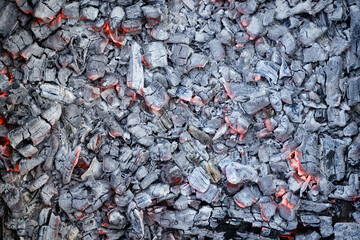 Burning coals background. Smoldering charcoal top view