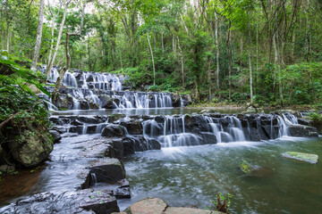 Samlan Waterfall, tier 1, multi-tiered waterfall in tropical Thailand forest with flowing water and stone steps.