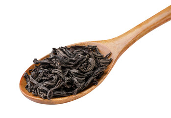 Dry black tea leaves in a wooden spoon close-up on a white. Isolated