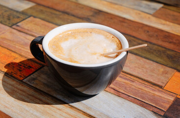 french cafe au lait in a ceramic cup on a table