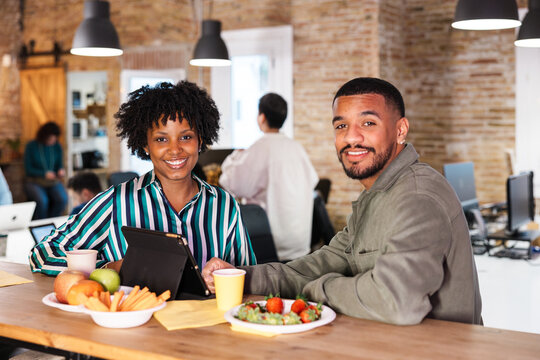 Business people enjoying break time with healthy food and digital tablet