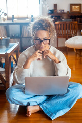 Middle-aged woman working from home on laptop. Mature female freelancer showing different facial...