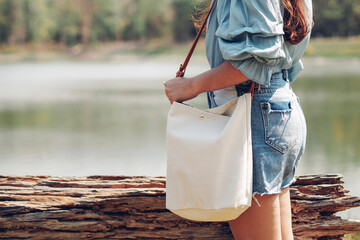Woman holding canvas tote bag. Eco friendly and Recycling concept. Mockup for design.