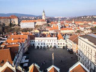 Cesky Krumlov, Czech Republic: Aerial view of Cesky Krumlov old town main square with the castle and fort in the background in Czech Republic on a sunny winter day.