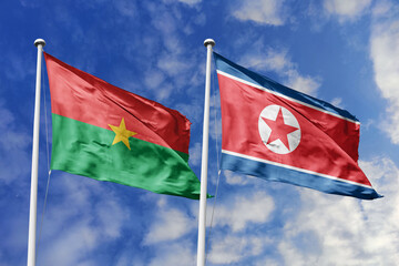 Flags of Burkina Faso and North Korea Waving Together Against a Blue Sky, Symbolizing Diplomatic Ties and International Relations