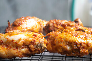 grilled chicken thighs, Grilling Chicken on grill rack by charcoal stove in Thai local kitchen selective focus  close up