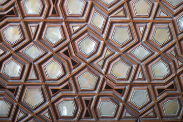 Intricate geometric wooden ceiling or panel design featuring interlocking polygons and...