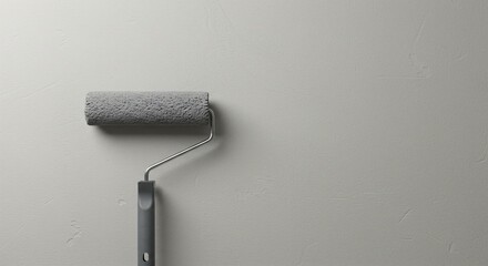 Fototapeta premium Paint roller on a freshly painted wall. Home renovation project concept. Do it yourself repair background with copy space.