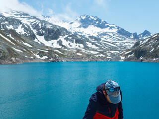 Man Hiking by Turquoise Alpine Lake in the French Alps – Lac des 7 Laux