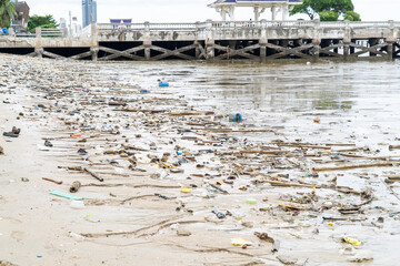A beach is covered with trash and debris