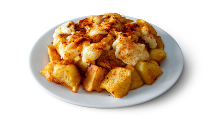 A plate of patatas bravas with aioli and spicy paprika, a typical Spanish tapa isolated on empty background