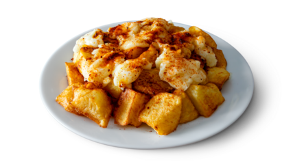 A plate of patatas bravas with aioli and spicy paprika, a typical Spanish tapa isolated on empty background