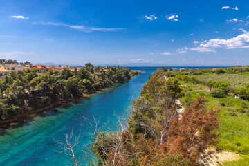 View of the canal of Nea Potidea with the majestic, snow-capped Mount Olympus in the background, Chalkidiki, Greece