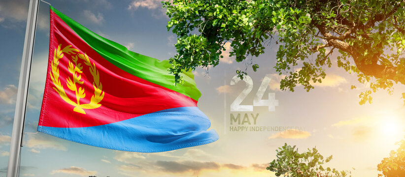 Eritrea flag waving in the sky. A couple hike and enjoy a break look at the top of the mountain adventure travel. Eritrea national flag for independence day.