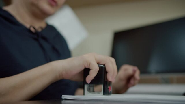 Stamping documents at office desk
