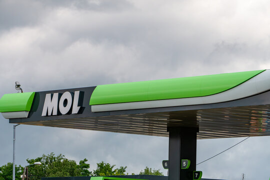 modern canopy of a MOL gas station featuring the company's distinctive green and white design with a prominent logo