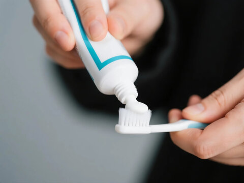 hands or toothbrush with toothpaste for dental care, hygiene or cleaning teeth at home. Closeup, male person or applying tube of paste for fresh breath, oral or mouth and gum protection at house