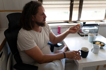 Freelancer working from home enjoying breakfast and coffee