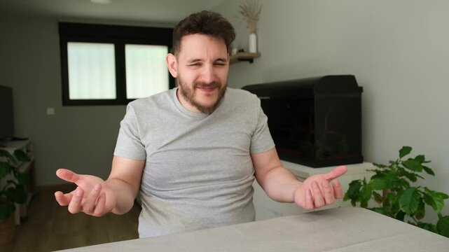 Man sitting at a table expressing distrust and denial through various hand gestures