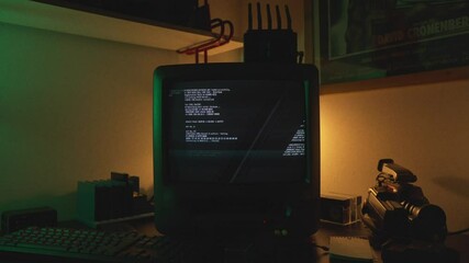Boot sequence on CRT next to camcorder in dim hacker workspace with colored light, alert malicious code system compromised