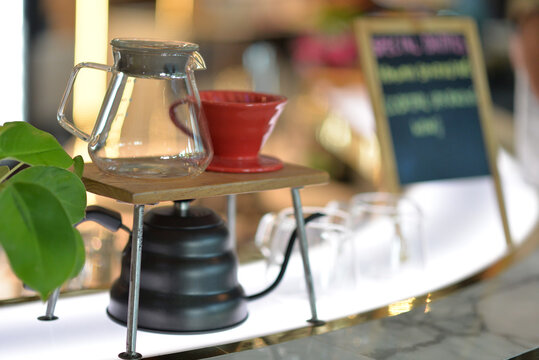 Hot tea in a glass cup on the kitchen table, a fresh morning beverage