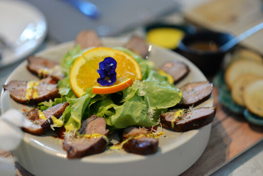  Grilled meat beautifully presented with gourmet food on a decorated table in a restaurant setting 