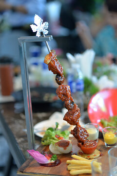BBQ Traditional Thai and Turkish desserts beautifully presented with gourmet food on a decorated table in a restaurant setting 